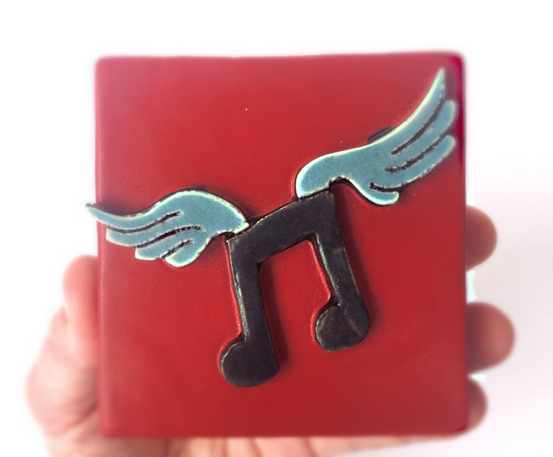 Clique Tile Musical Note With Wings